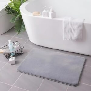 Grey soft faux rabbit fur rug placed in bathroom and home décor space by Prisha Cart
